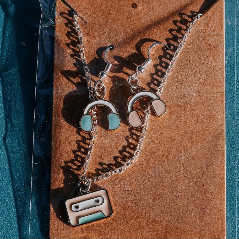 Headphone earrings and cassette necklace.